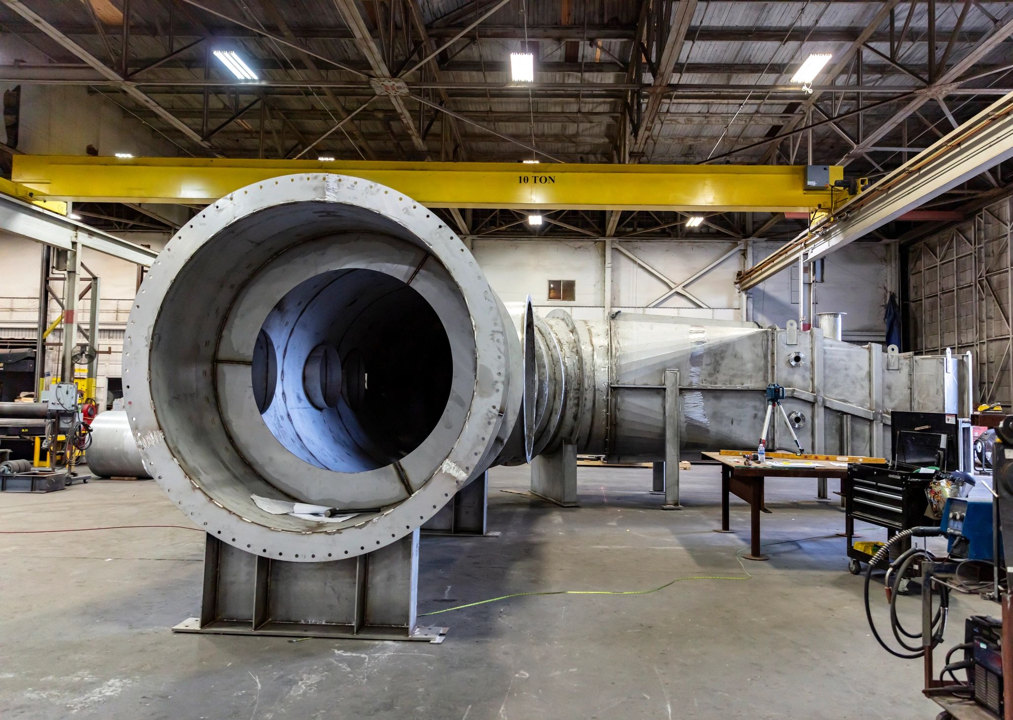 Metal fabrication facility interior showing large industrial metal components